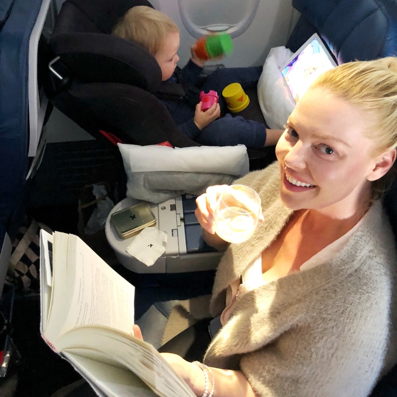 Katherine Heigl enjoying her flight with a cocktail and a good book